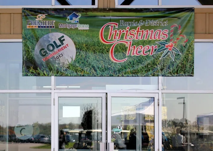 The Barrie and District Christmas Cheer Golf Tournament 2013 banner, with the Mortgage Sense logo, over the clubhouse doors